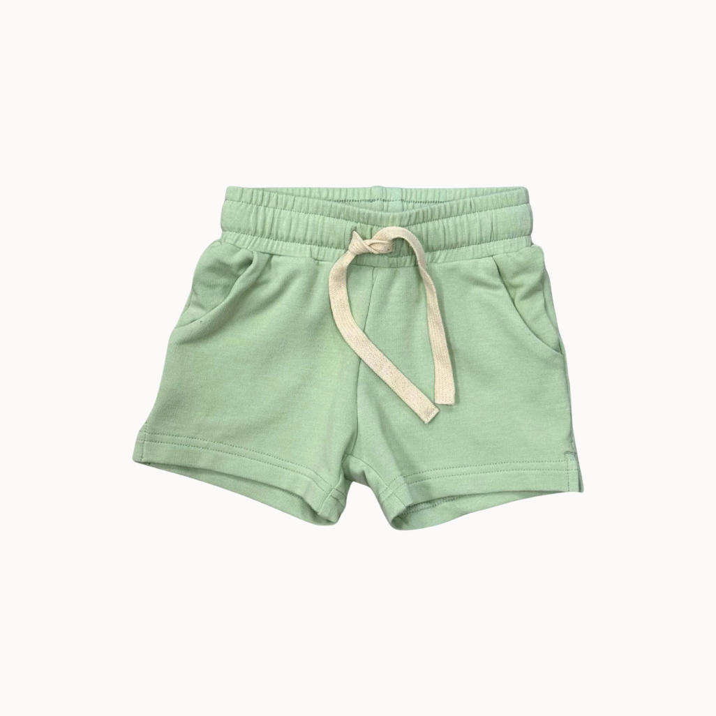 Light green shorts with a drawstring on a white background