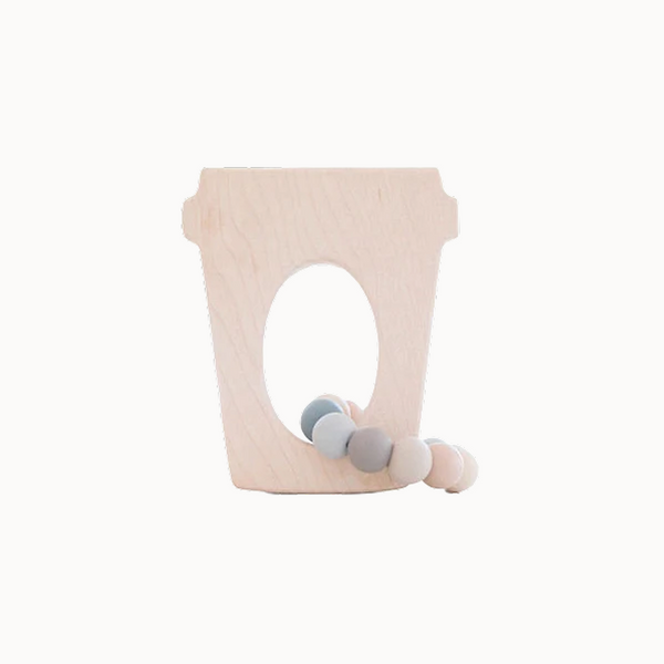 Coffee cup teether toy on table on empty background