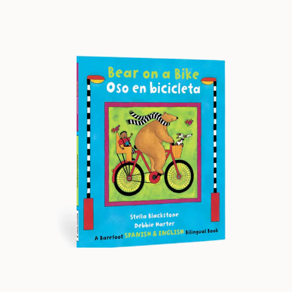 Children's book cover with a bear on a bike illustration and bilingual text