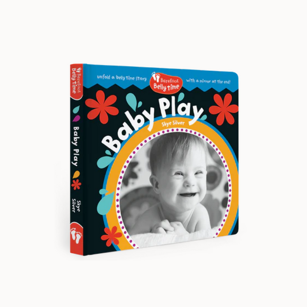 Book titled 'Baby Play' with a black and white photo of a baby on the cover, featuring colorful floral designs.