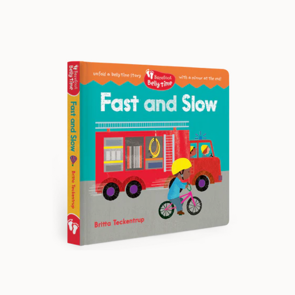 Book titled 'Fast and Slow' with a fire truck and child on bike illustration on empty background