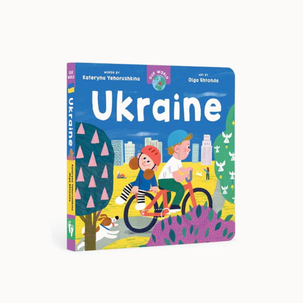 A board book cover featuring illustrations of a diverse group of people, a cityscape, and elements of Ukrainian culture such as a bicycle, a book, and a kite.