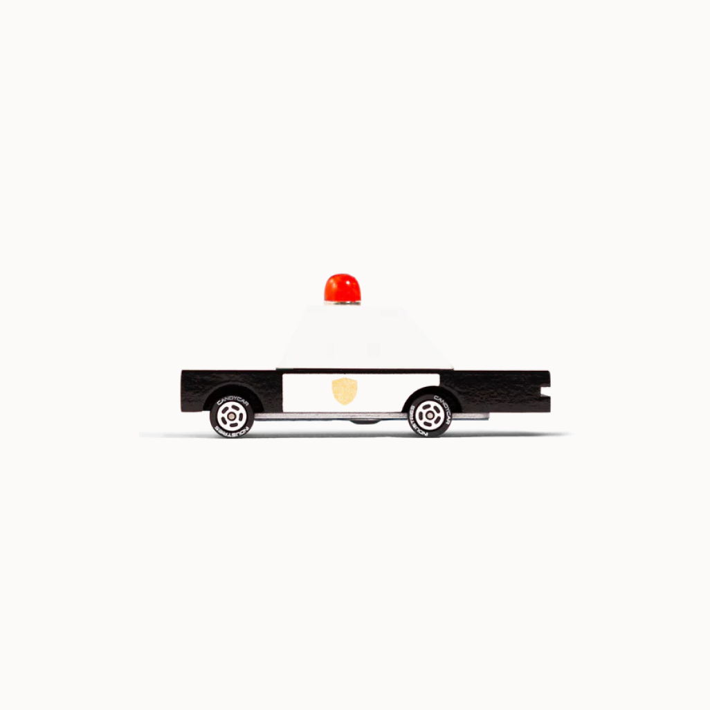 Toy police car with a red light on a white background