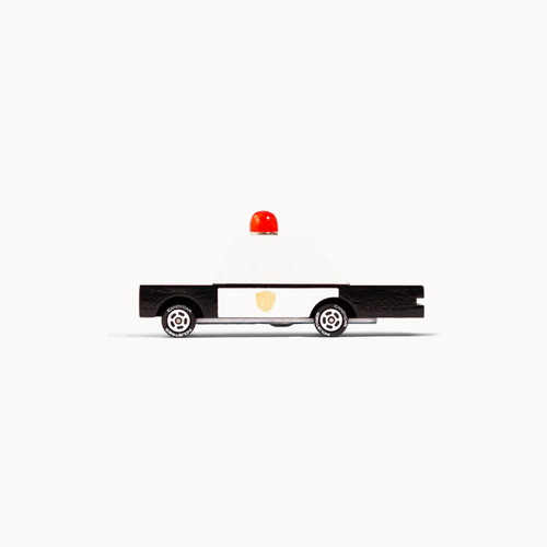 Toy police car with a red light on a white background