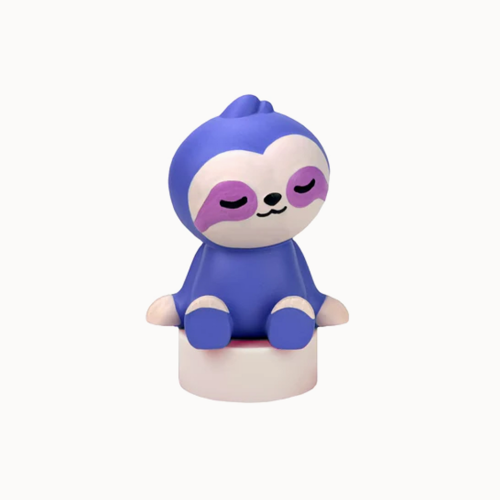 Purple sloth figurine with closed eyes on a white background