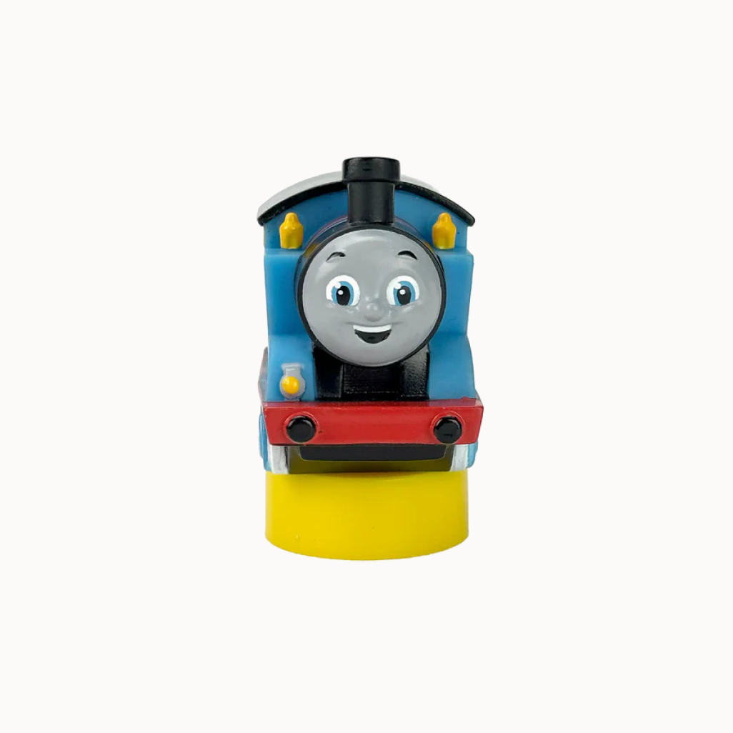 Toy train engine with a smiling face on a white background