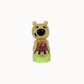 Toy figure of a bear holding a potted plant on a white background