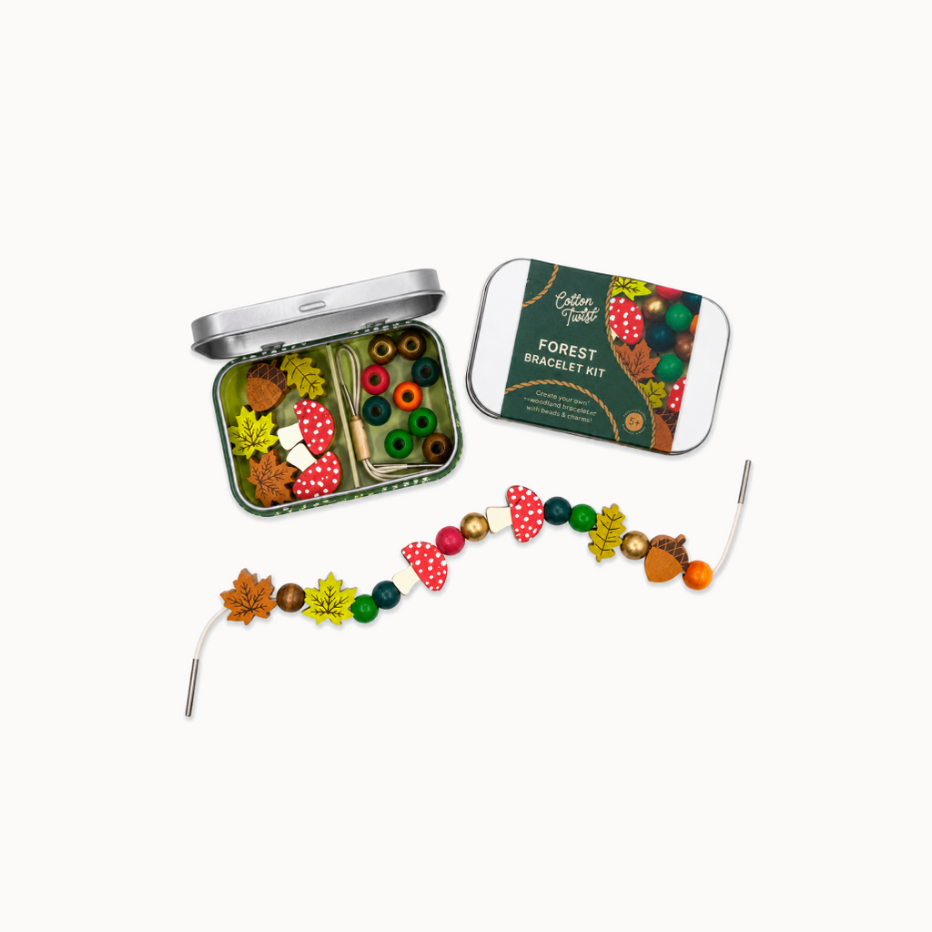 Forest-themed bracelet kit with colorful beads and a tin on a white background