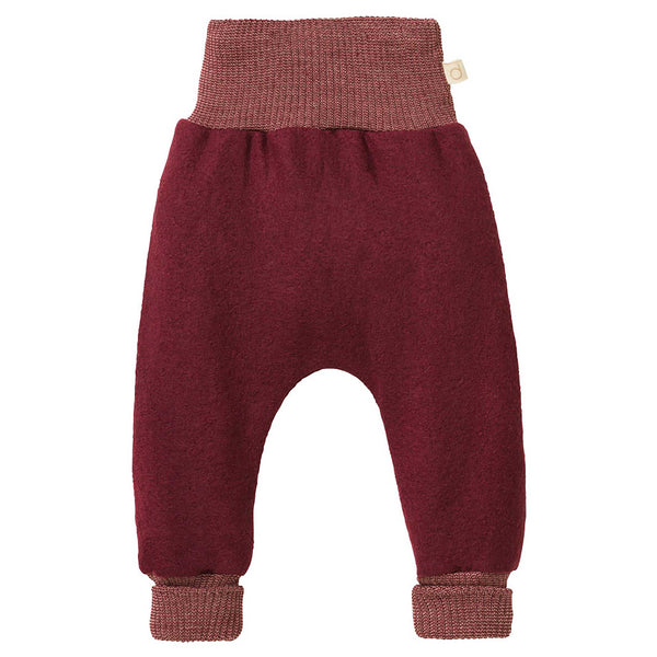 A pair of maroon boiled wool bloomers for babies, with a high waistband and long leg cuffs.