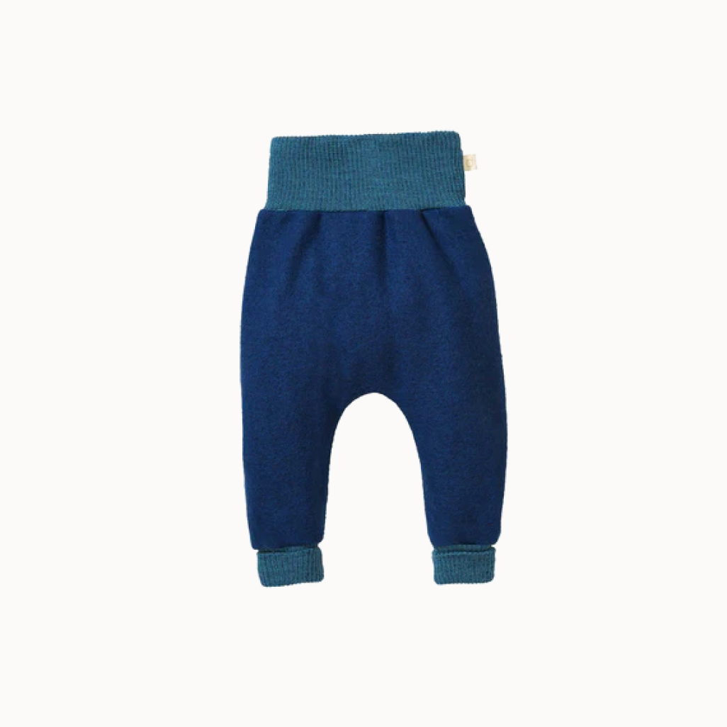 A pair of blue boiled wool bloomers for babies, with a high waistband and long leg cuffs.