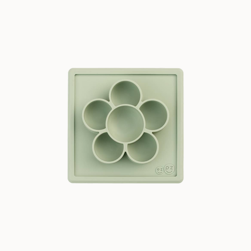 Light green silicone mold with circular compartments on a white background