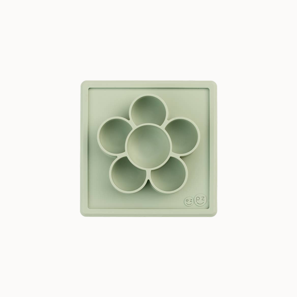 Light green silicone mold with circular compartments on a white background