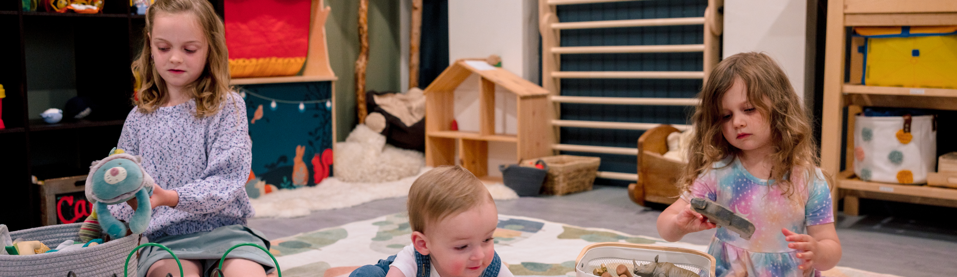 Kis playing with stuffies in a play room