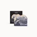 Marbled purple and white soap with Finchberry packaging in the background
