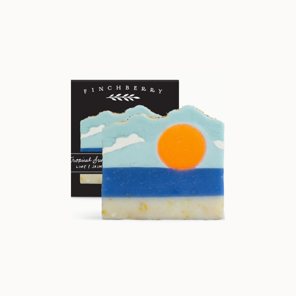 Decorative soap with mountain and sun design in front of a Finchberry branded box.