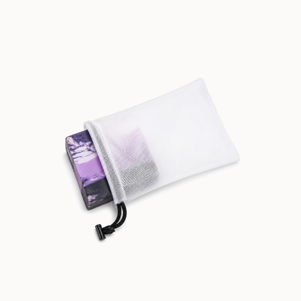 White mesh pouch with a purple item partially visible inside on a white background