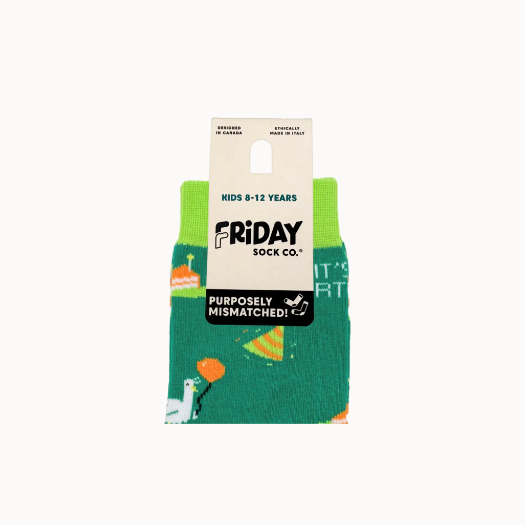 Green socks with dinosaur pattern in packaging labeled 'Friday Sock Co.'