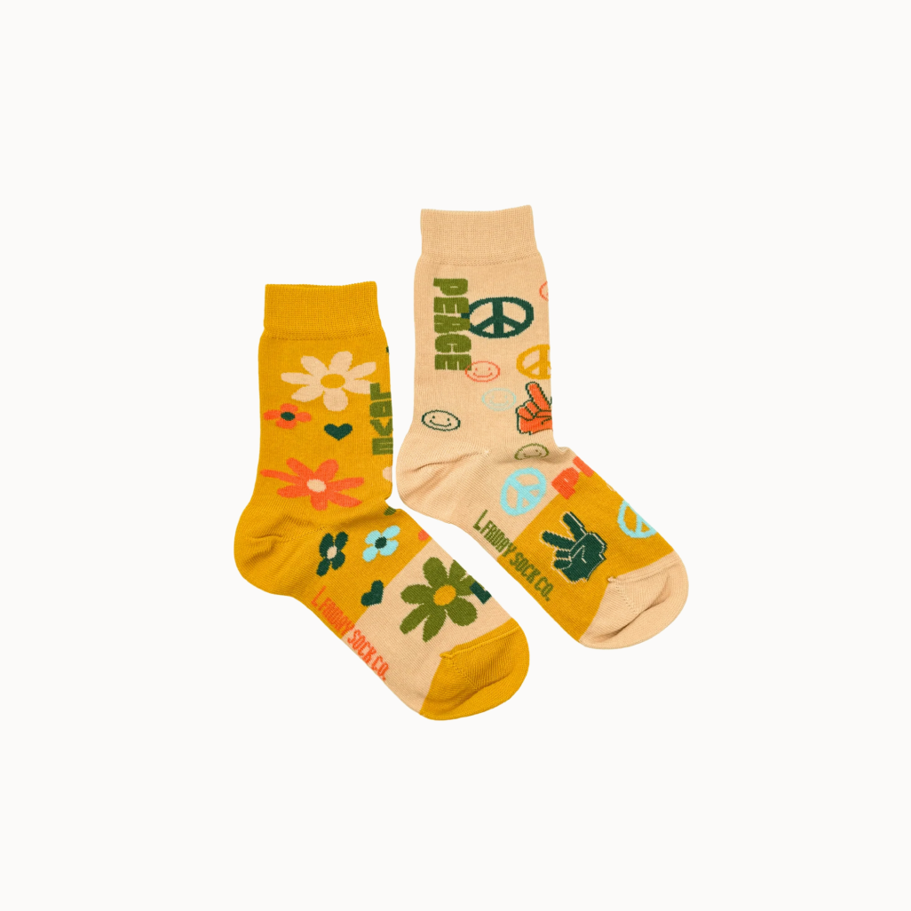 Two pairs of socks with peace signs and floral designs on a white background.