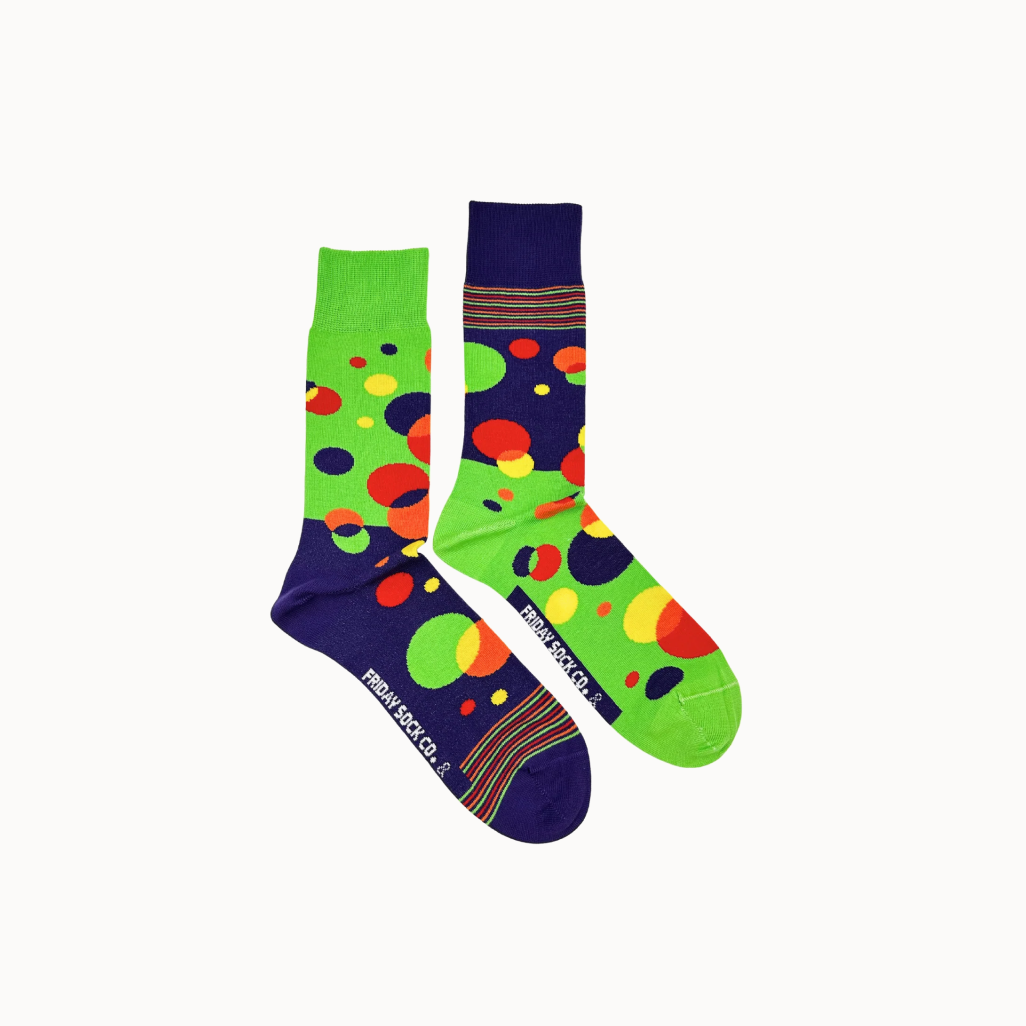Two colorful socks with polka dot pattern on a white background.
