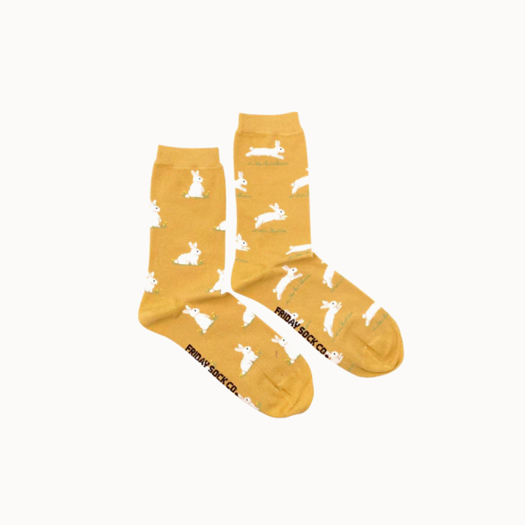 yellow socks with bunnies on them on white background