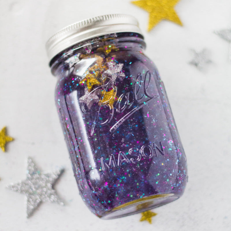 Purple glittery jar with stars on a white background