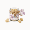 Jar with sliced white lotion drops on a white background