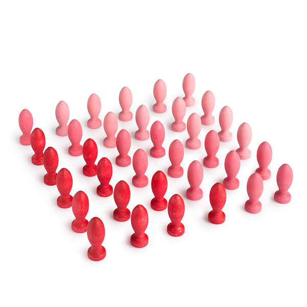 Red and pink silicone butt plugs arranged in a pattern on a white background