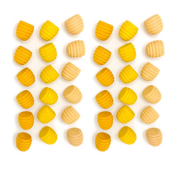 Yellow beehive shaped toys on white background