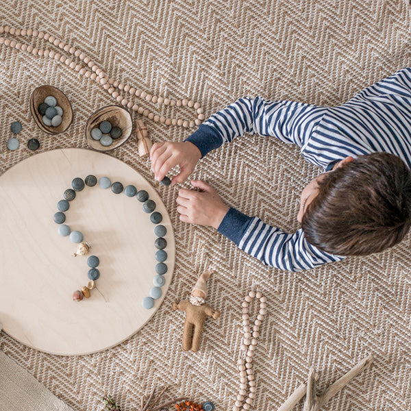 Child playing with toys on a textured floor