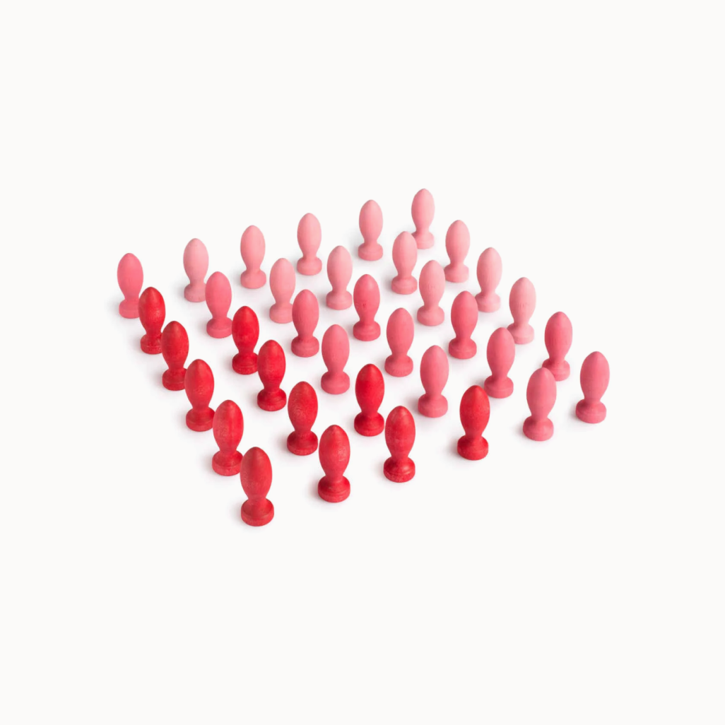 Set of red and pink wooden flower petals on a white background