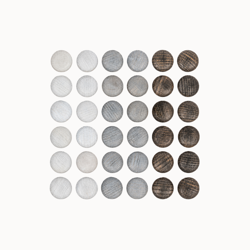 Set of round wooden stones in various shades of gray and brown on a white background