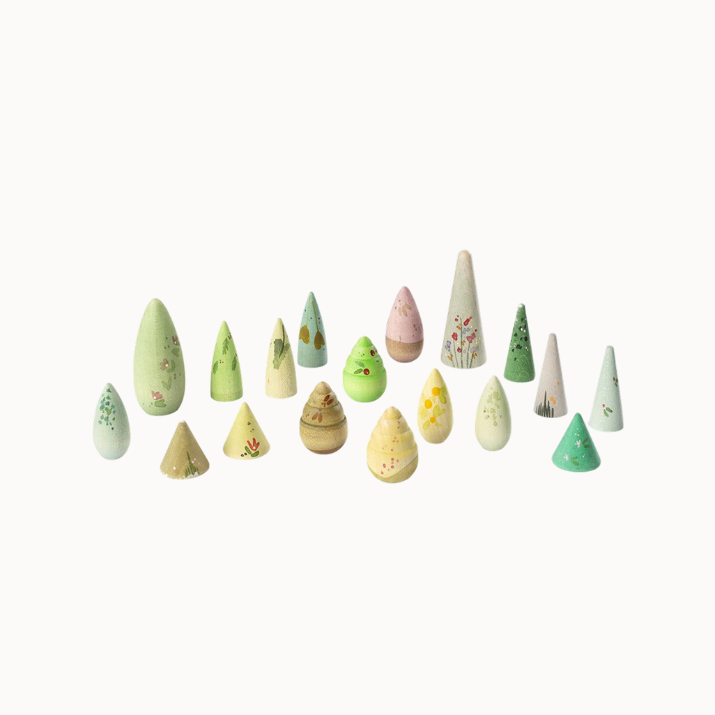 Set of small wooden trees with various designs on a white background