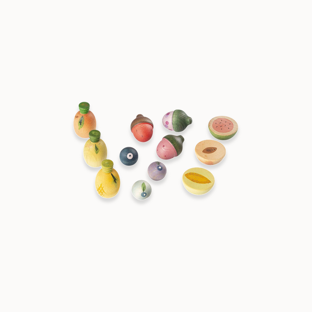 Small wooden play fruits on a white background