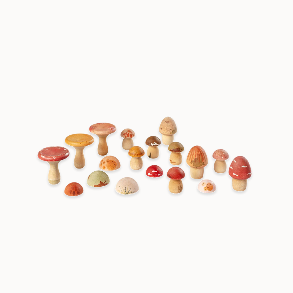 Set of colorful wooden mushrooms on a white background
