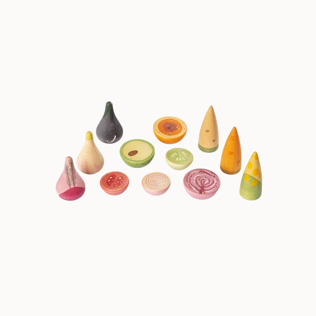 Set of colorful wooden toy fruits and vegetables on a white background