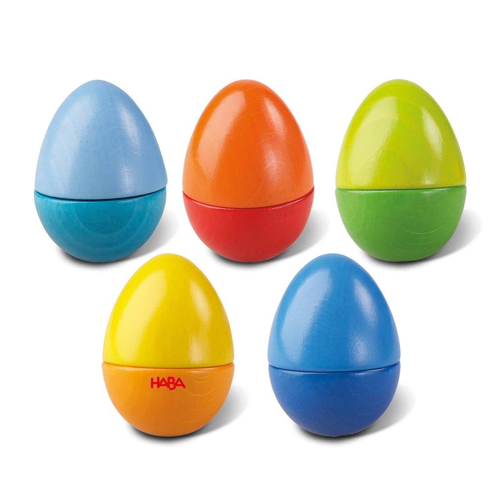 Set of colorful plastic eggs with HABA logo on a white background