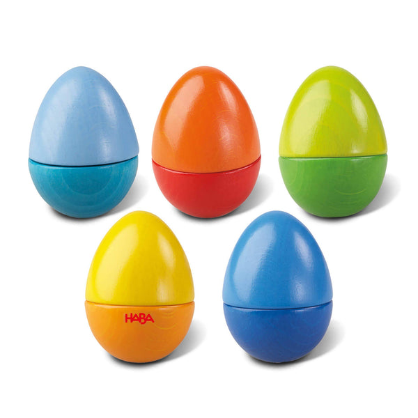 Set of colorful plastic eggs with HABA logo on a white background