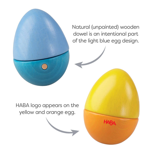Two colorful eggs with a wooden dowel and HABA logo on a white background