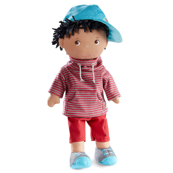 Doll wearing a red striped hoodie and red pants with a blue hat on a white background
