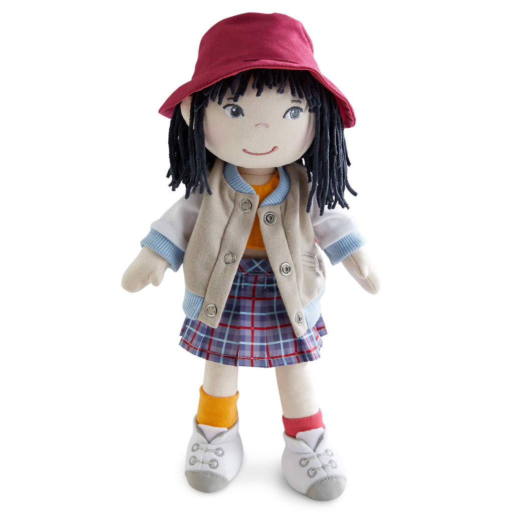 Stuffed doll with a red hat, beige jacket, plaid skirt, and orange socks on a white background