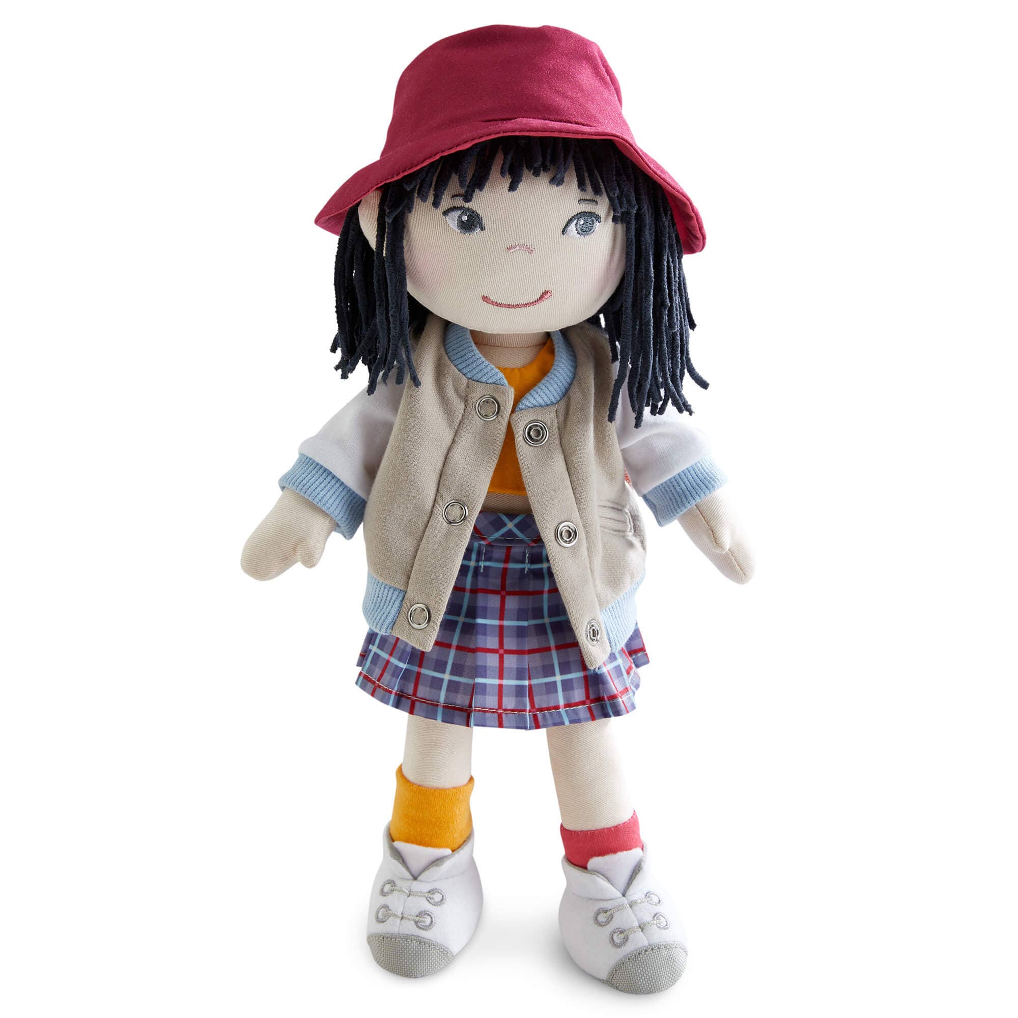 Stuffed doll with a red hat, beige jacket, plaid skirt, and orange socks on a white background