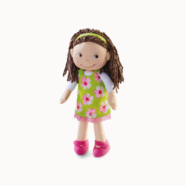 Plush doll with brown hair, green dress with pink flowers, and pink shoes on a white background