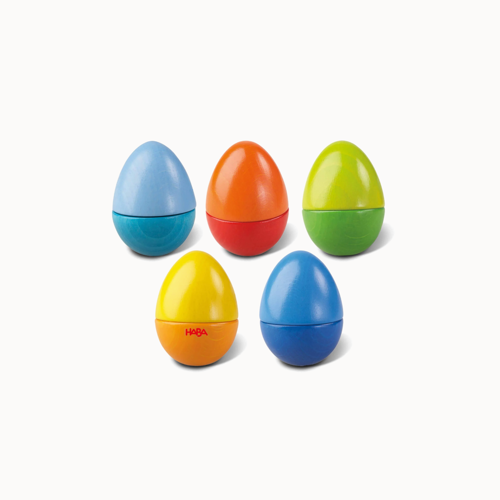 Set of colorful plastic eggs with HABA logo on a white background