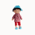 Doll wearing a red striped hoodie and red pants with a blue hat on a white background