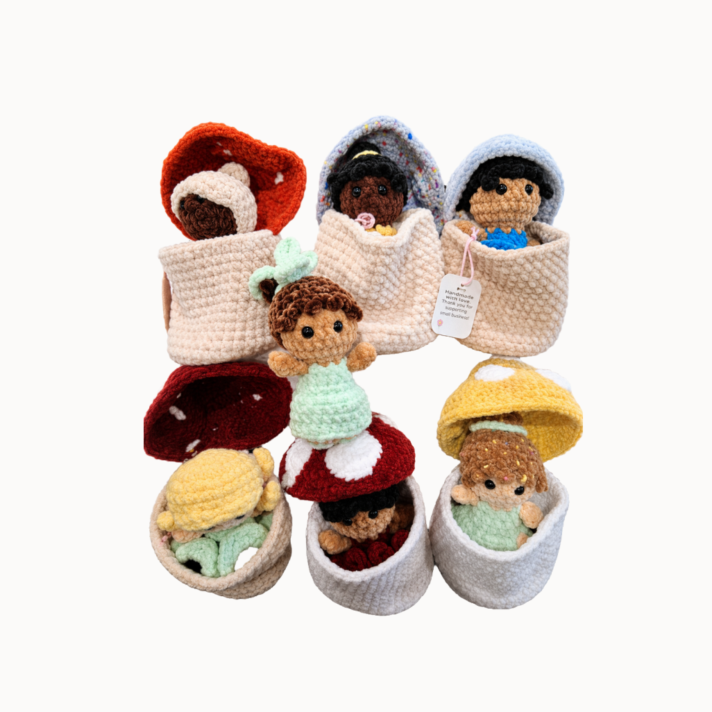 Group of crocheted fairies in their crocheted homes 