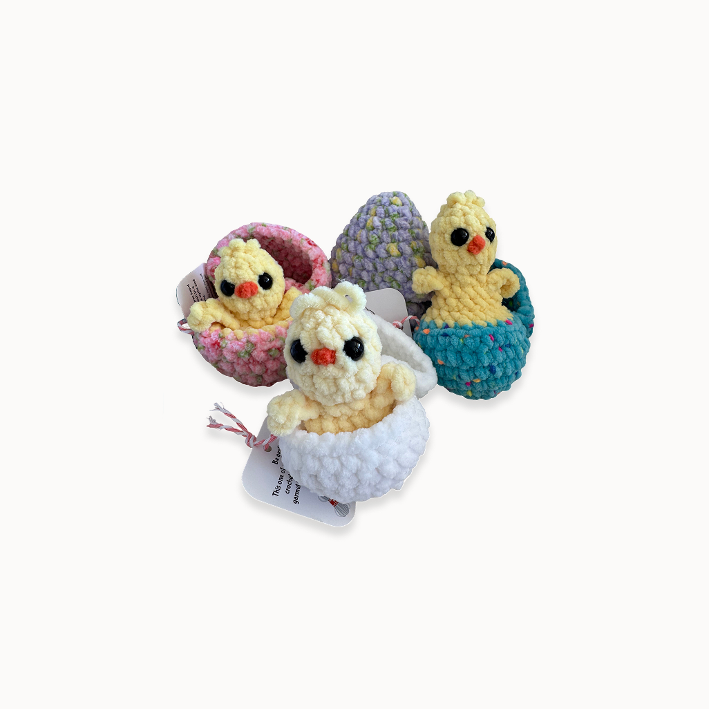 Colorful plush toys with chicks on a textured fabric background