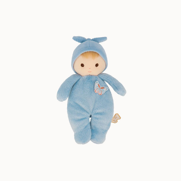 Plush toy baby doll in a blue outfit with a butterfly design on a white background