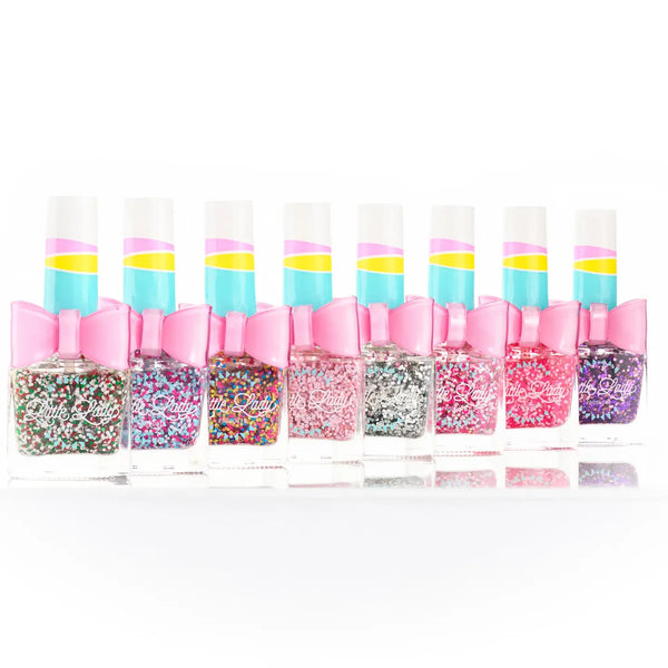 Set of nail polish bottles with colorful designs and pink caps on a white background