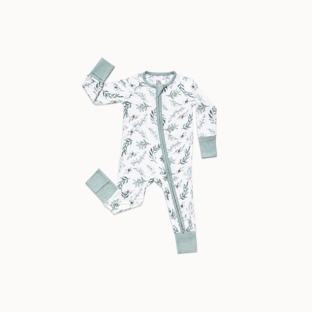 Baby onesie with floral pattern and matching items on a white background