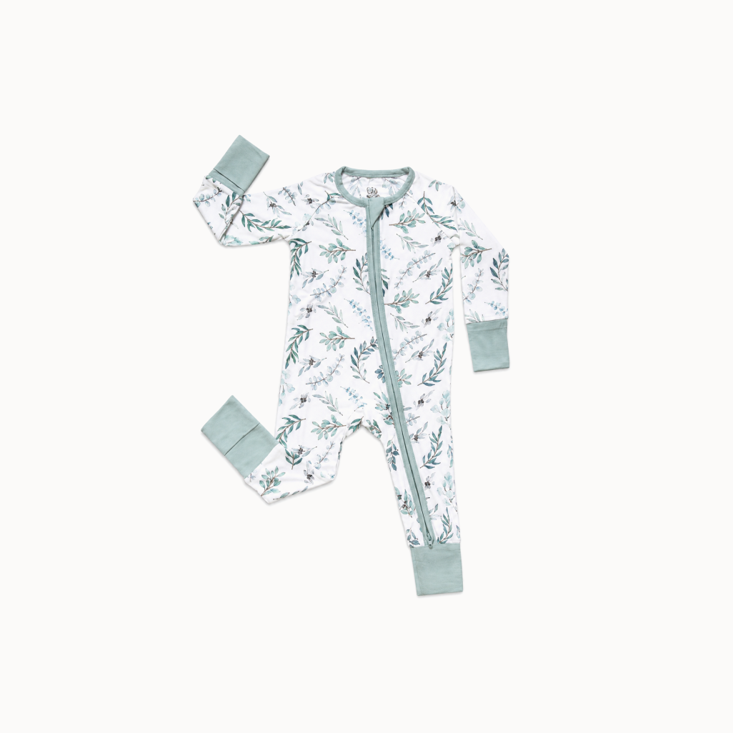 Baby onesie with floral pattern and matching items on a white background